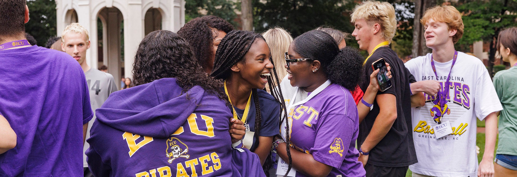 A group of students laugh as they play an icebreaker game to meet other admitted students.